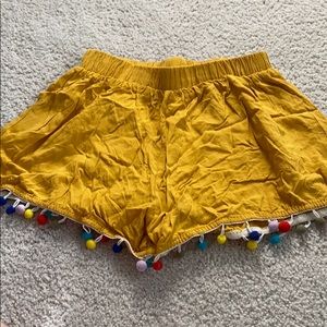 yellow shorts with rainbow pom poms🌈